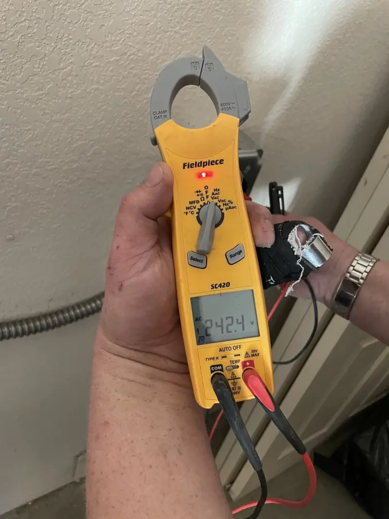 Voltage testing with clamp meter during Electrical Installation Services in Nellis AFB